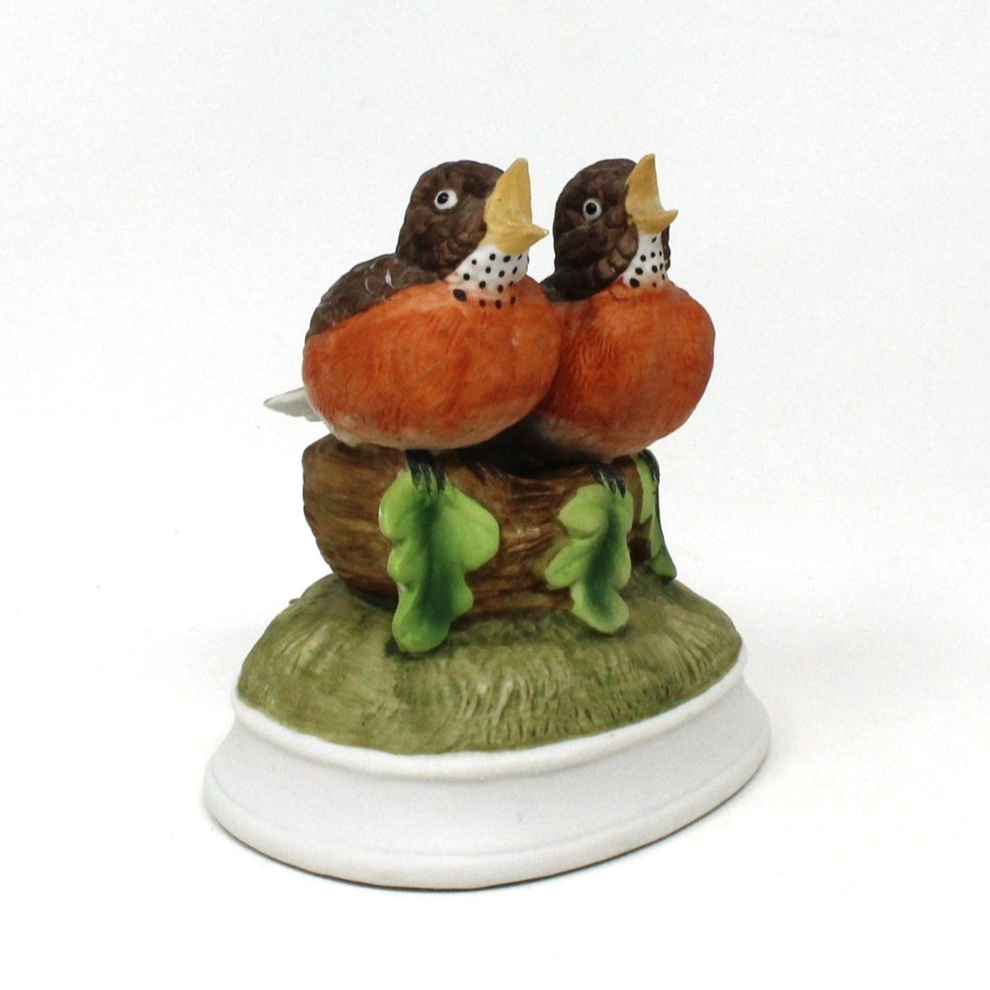 A vintage Gorham porcelain musical figurine featuring two robins perched on a nest with a music box base.