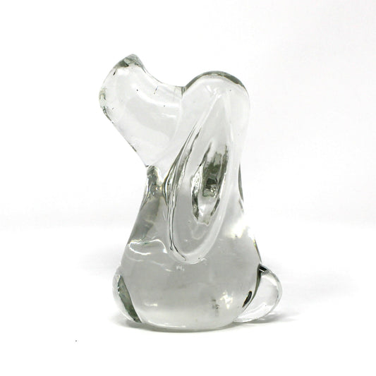 A small sculptural glass figurine, shaped like a Beagle or Hound Dog, made of clear glass