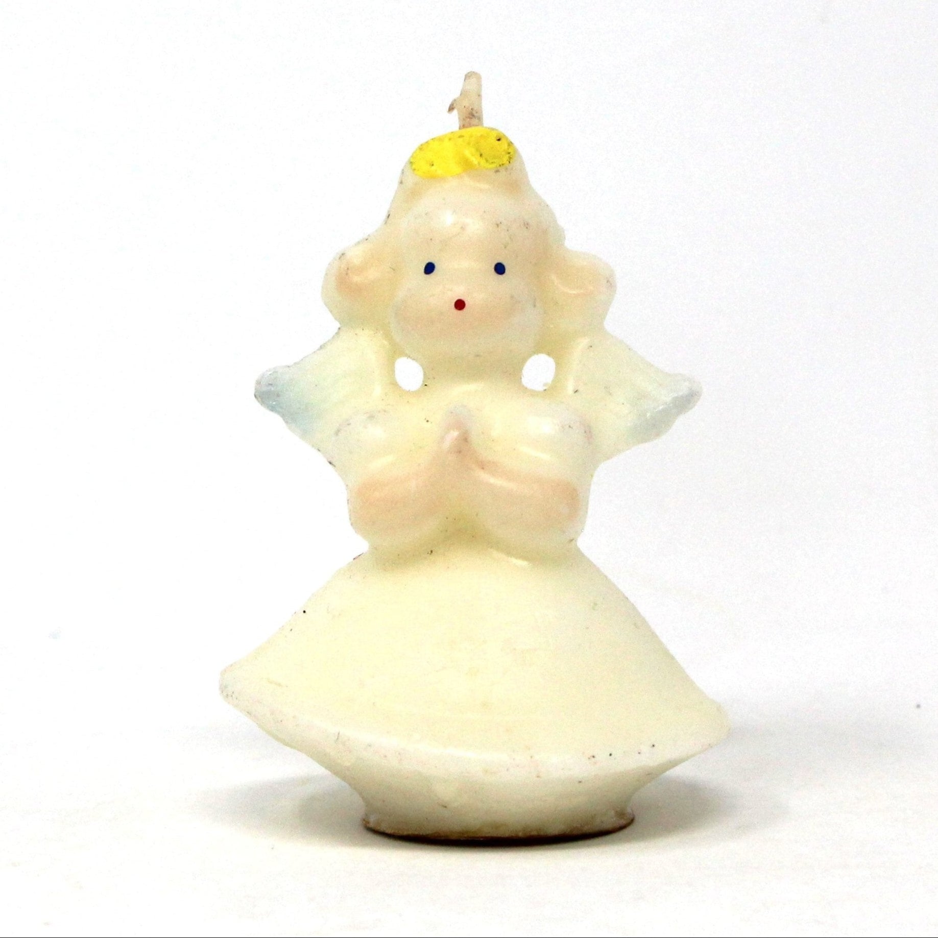 A vintage Gurley novelty candle depicting a figural angel, wearing a white gown with blue eyes and blond hair, never been burned.