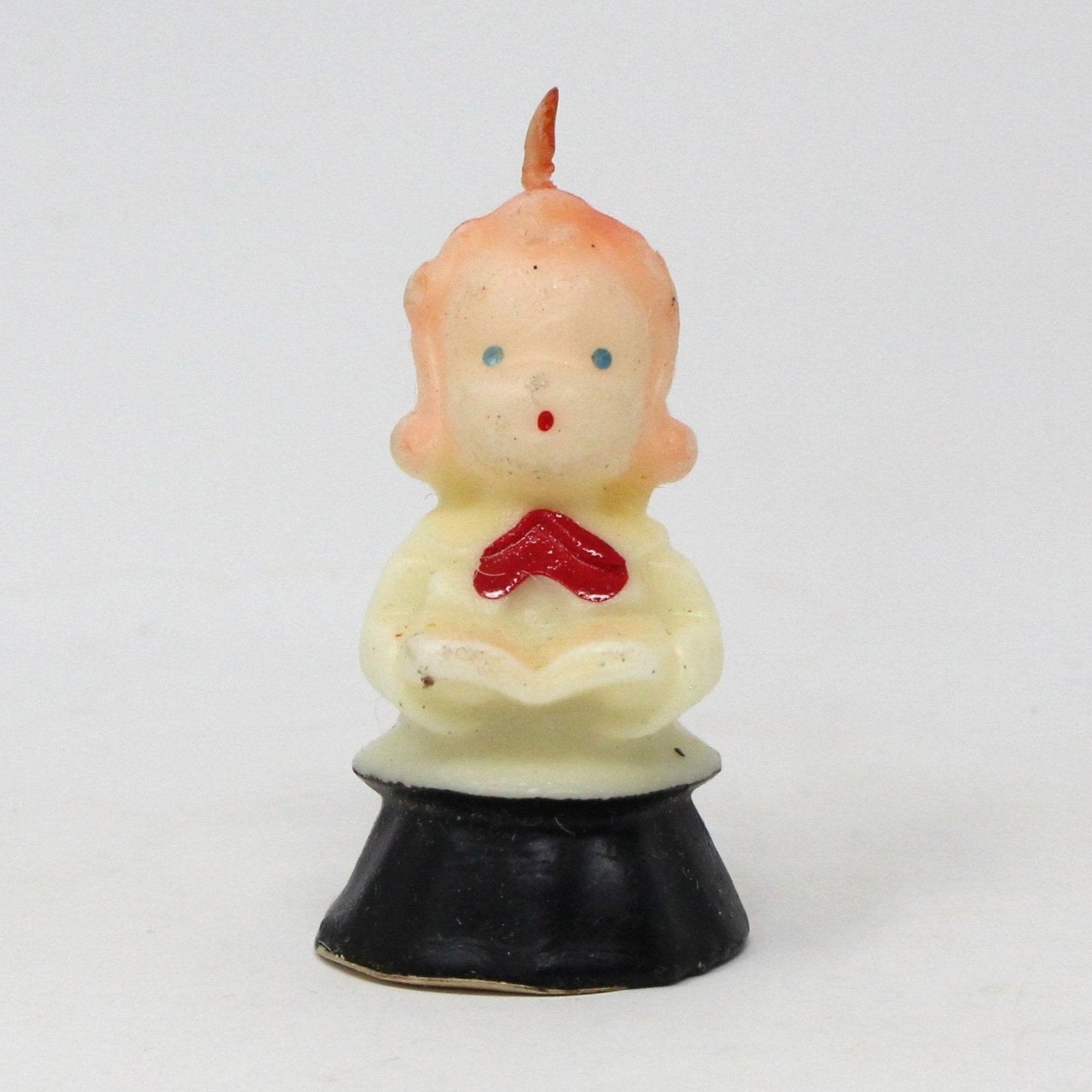 Vintage Gurley decorative candle in the shape of a choir singer girl with a red bow and black and white gown.  Never been used.