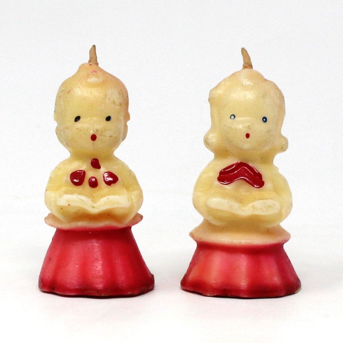 Two vintage Gurley novelty candles shaped like choir singers, boy and girl.  Both with red hair and a red and white robe, both unused.