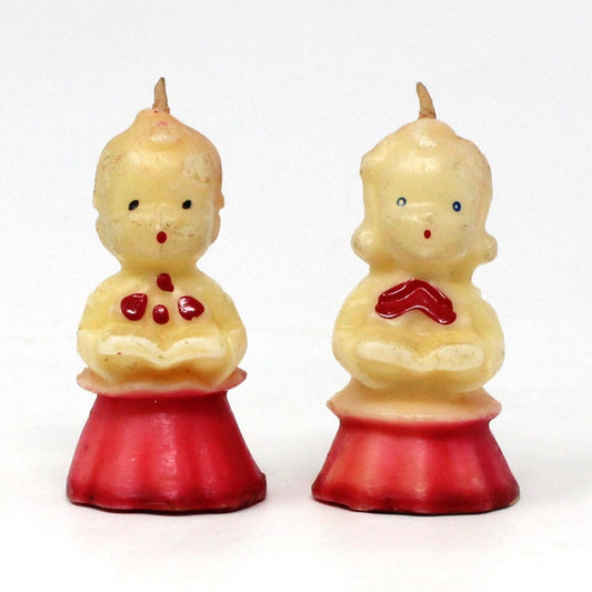 Two vintage Gurley novelty candles shaped like choir singers, boy and girl.  Both with red hair and a red and white robe, both unused.