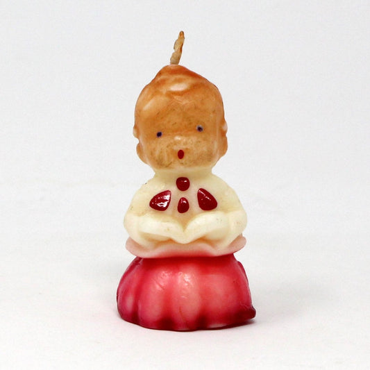 A vintage Gurley decorative candle in the shape of a choir singer boy caroler with red hair and a red & white choir gown, complete with a necktie.