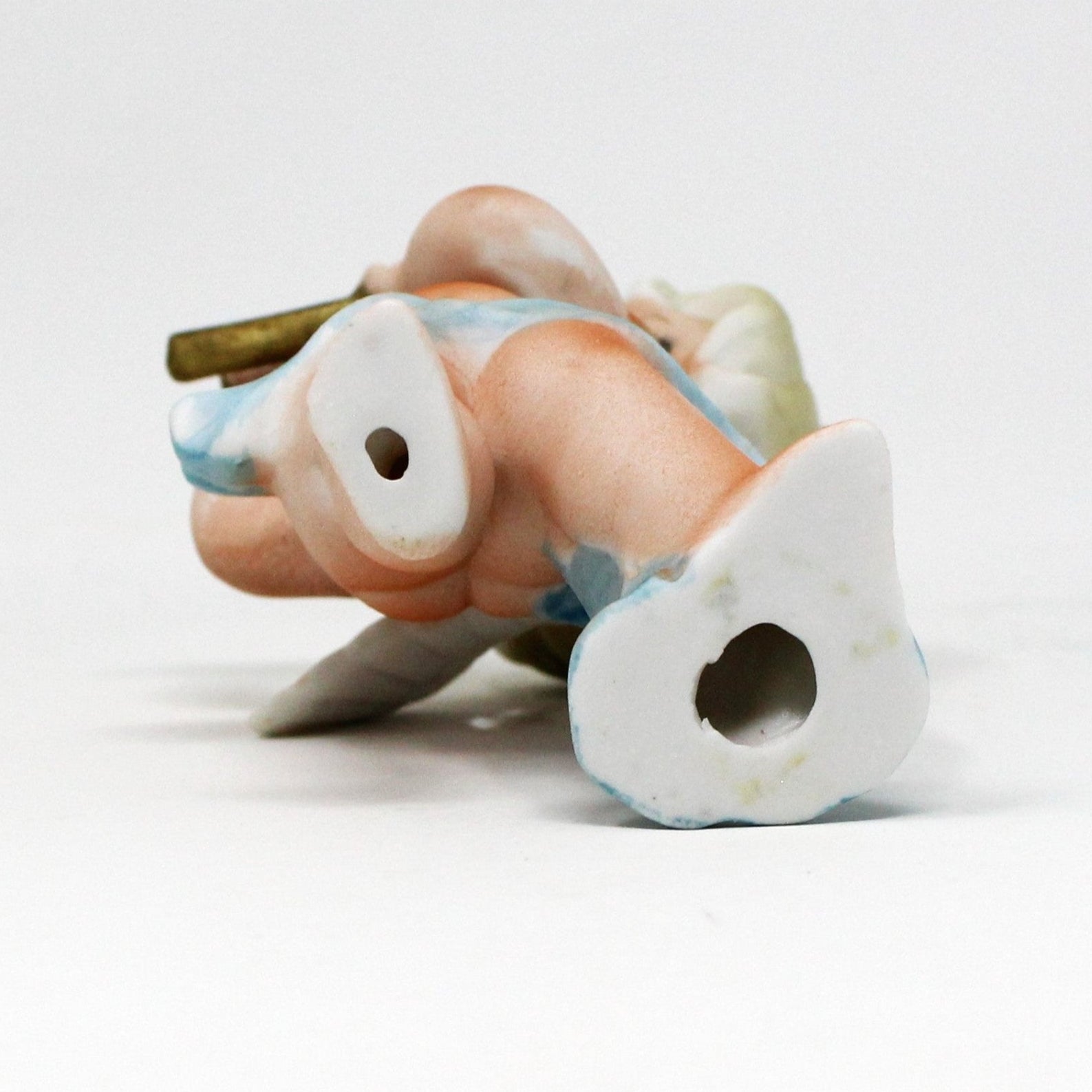 Bottom view of vintage angel figurine.  Hollow bisque porcelain.