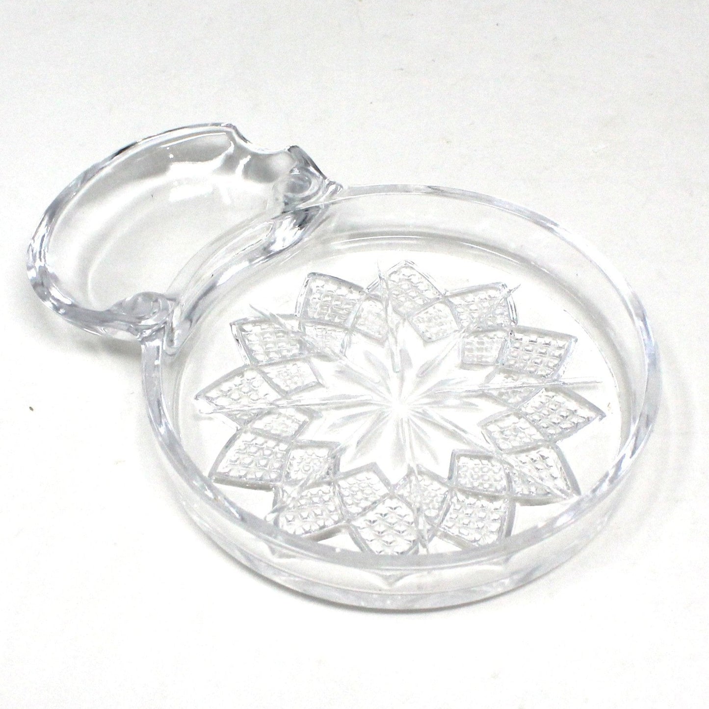 Vintage Fostoria Coaster. Clear crystal coaster with a Poinsettia flower design and a spoon rest extension.