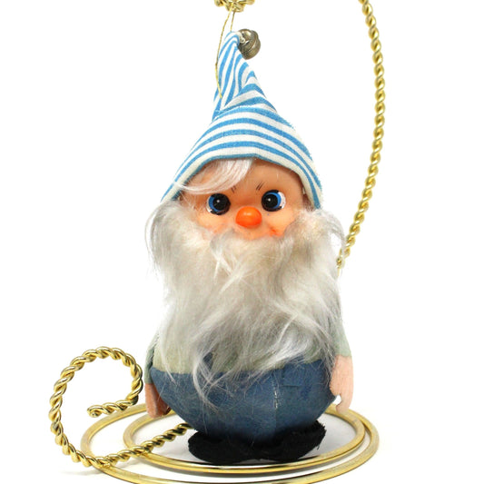 vintage Christmas ornaments featuring jolly elves with long beards, one wearing blue overalls and a striped hat with a bell, and the other with a similar outfit but without the mallet.