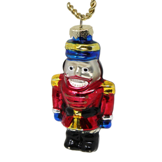 A vintage hand-painted blown glass nutcracker ornament.   Nutcracker soldier in red, blue, black, gold, and silver colors.