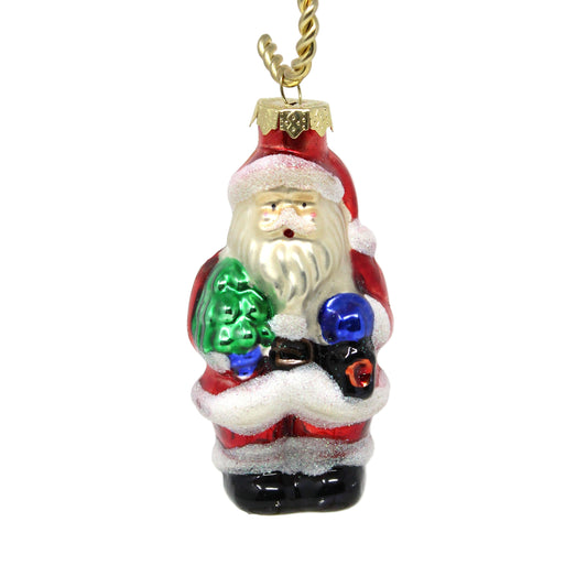 A vintage glass ornament depicting Santa Claus with a Christmas tree and a lantern.