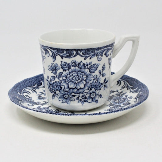A vintage J&G Meakin Avondale Blue ironstone coffee cup with blue and white floral patterns, accompanied by a saucer.