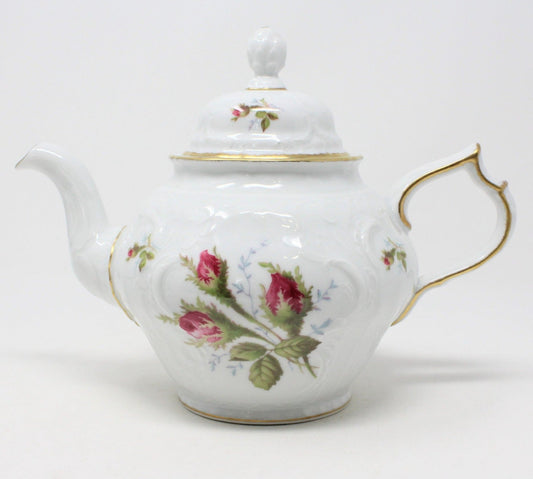 A vintage Rosenthal Sanssouci teapot with the Moss Rose pattern, featuring pink rose buds, gold accents, and an embossed porcelain design. The teapot has a pineapple finial on the lid and is displayed against a white background.