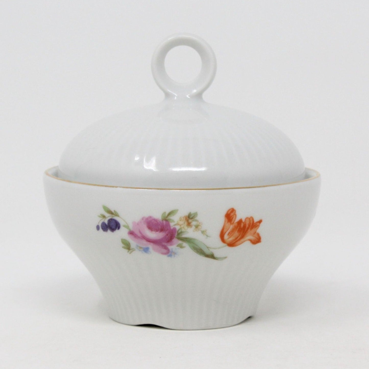 A vintage German porcelain sugar bowl by JLMenau. With a floral pattern, featuring a lid with gold accents and rounded finial on lid