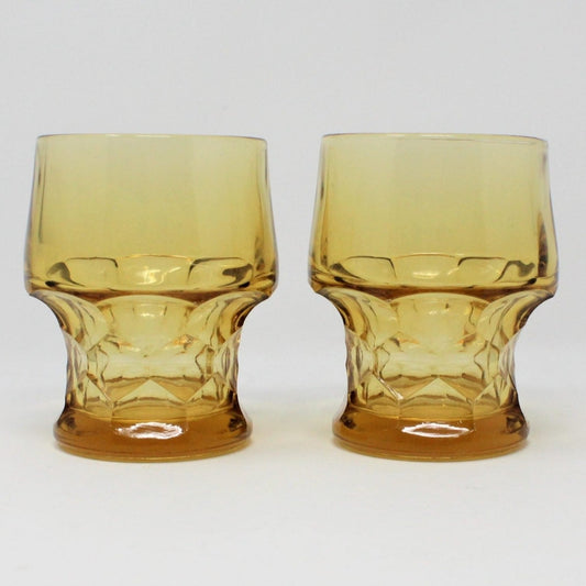 A pair of vintage amber-colored glass tumblers with a honeycomb pattern.