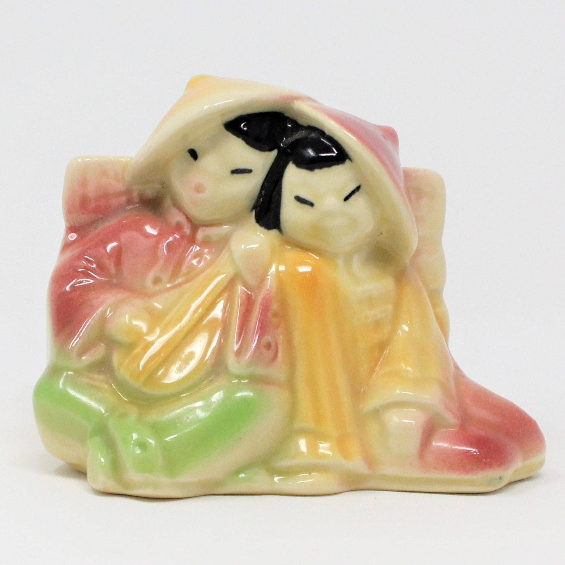 Vintage ceramic planter from Shawnee Pottery, featuring an Asian couple with the man playing a mandolin, in a multicolored costume.