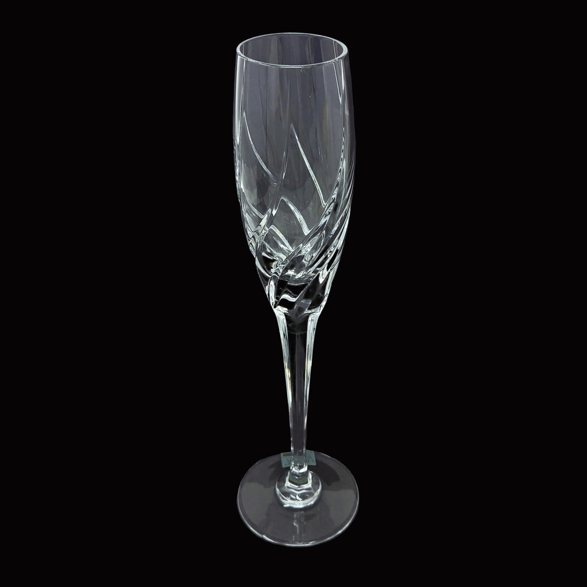 A clear cut-crystal champagne flute with diagonal faceted patterns