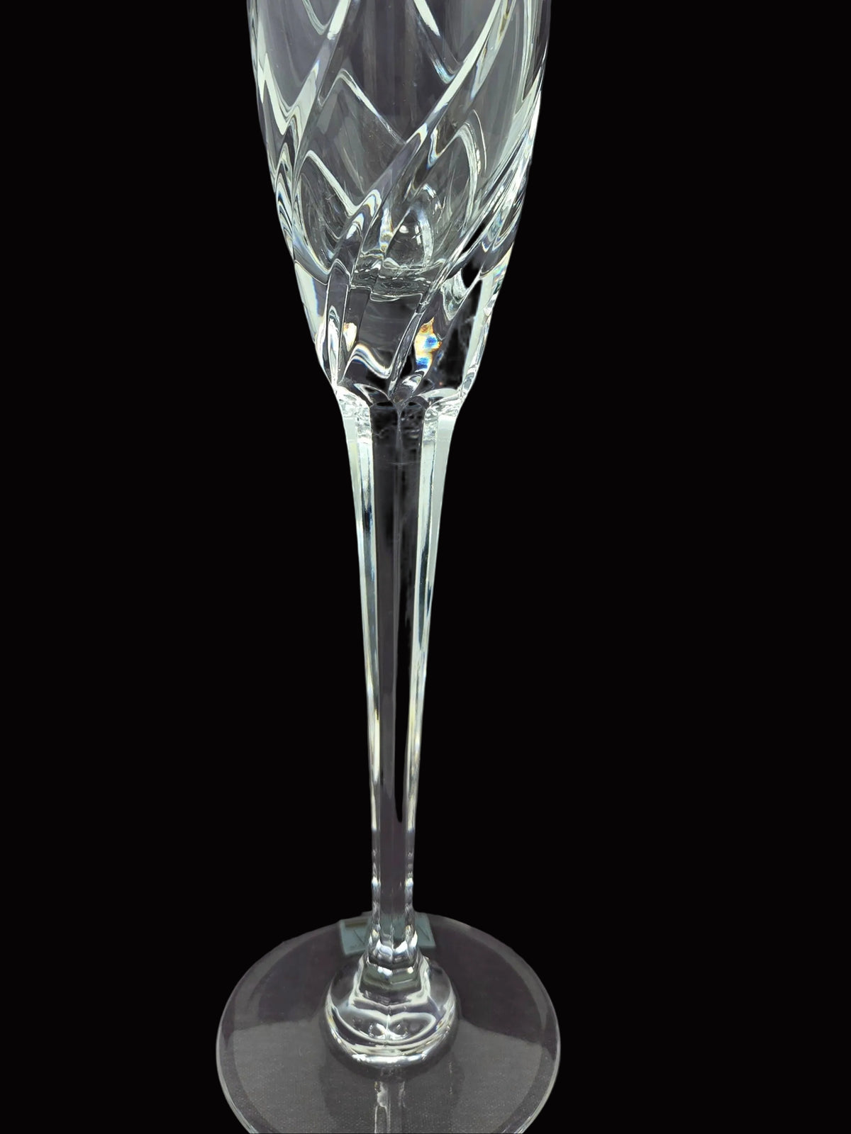Up close view of the stem on a  clear cut-crystal champagne flute from Mikasa in their Olympus pattern.  