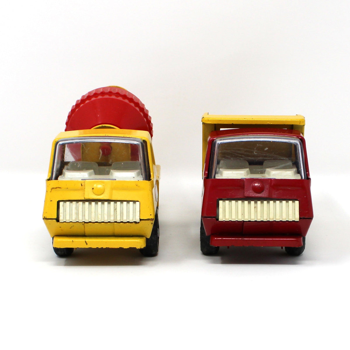 Front view of pair of vintage collectible Tonka Toy Trucks: Cement Mixer & Dump Truck, Pressed Steel, Yellow / Red, 1970s