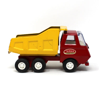 Side view of vintage collectible Tiny Tonka Toy Dump Truck, Pressed Steel, Yellow / Red, 1970s