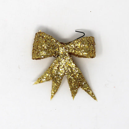 vintage celluloid bow shaped Christmas ornaments, covered in gold glitter. 