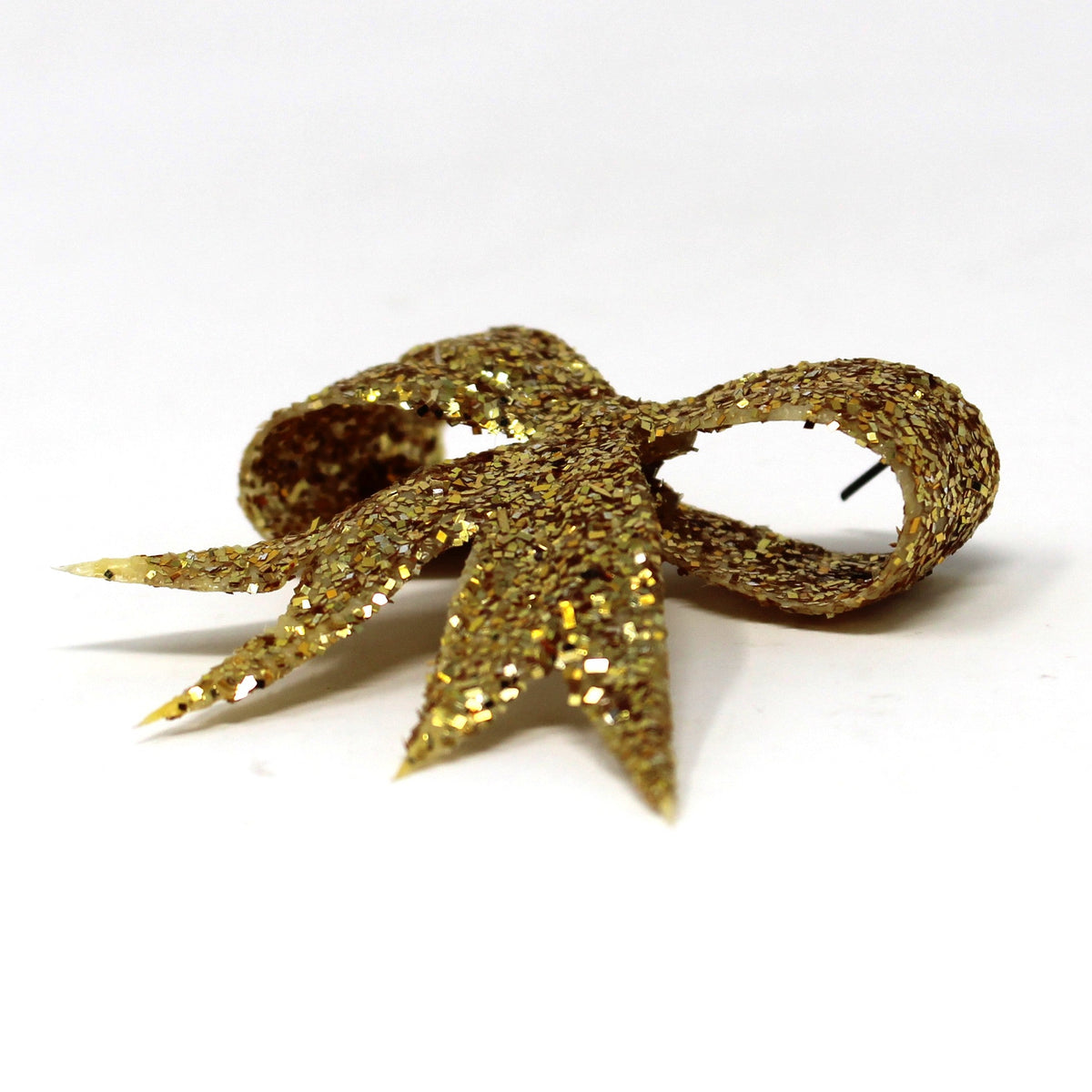 side view of vintage celluloid Christmas ornament, gold glitter