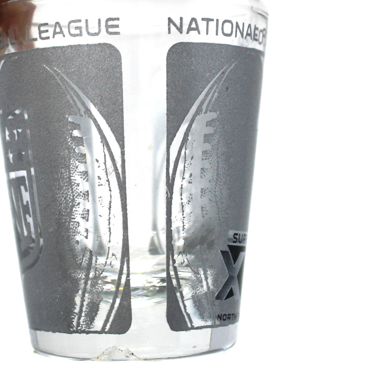 close up view of side football graphics on super bowl souvenir shot glass