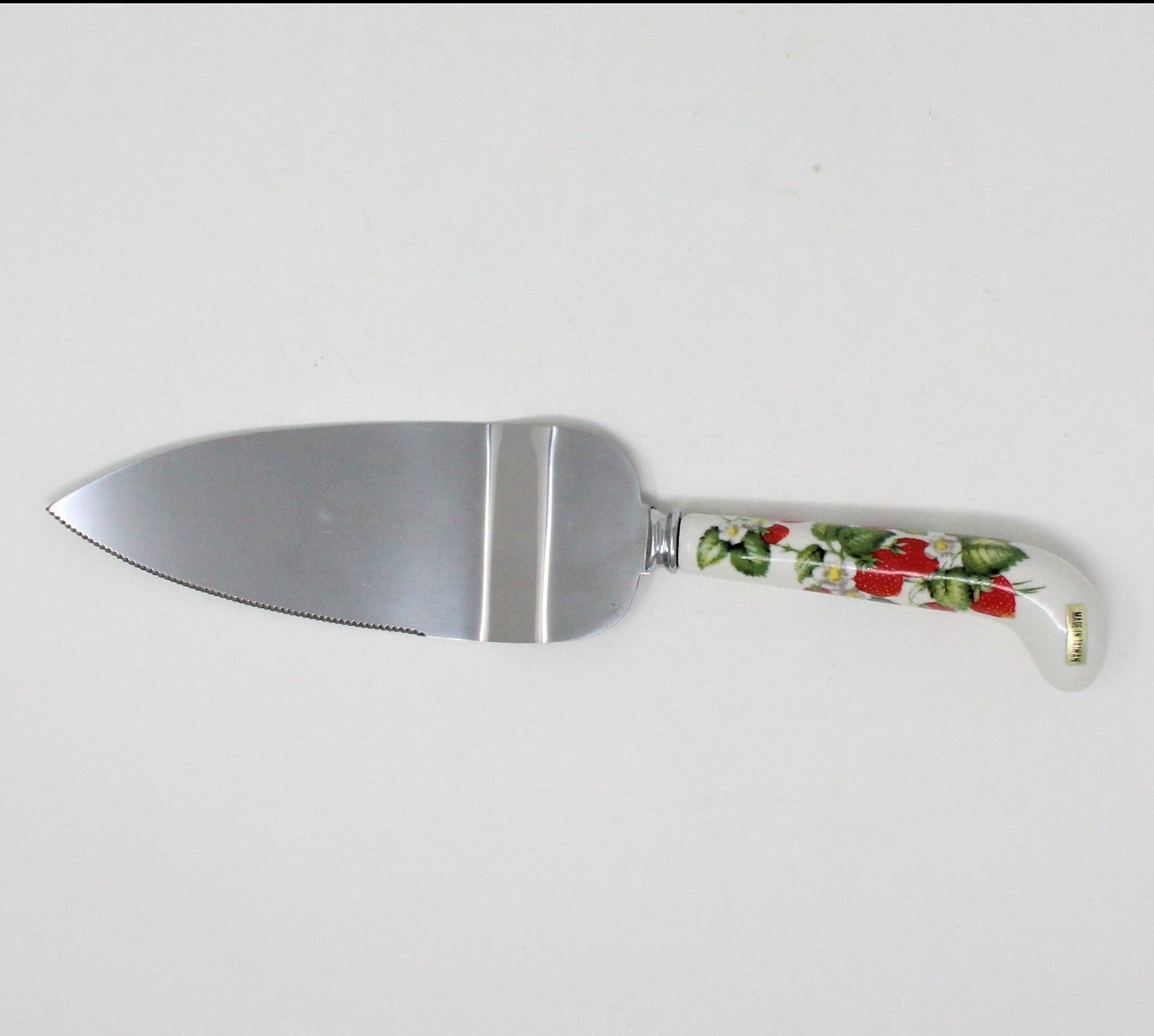 Vintage cake knife with a stainless steel blade and a porcelain handle featuring a strawberries pattern