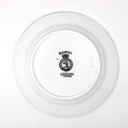 backside of antique plate with a logo on a white background
