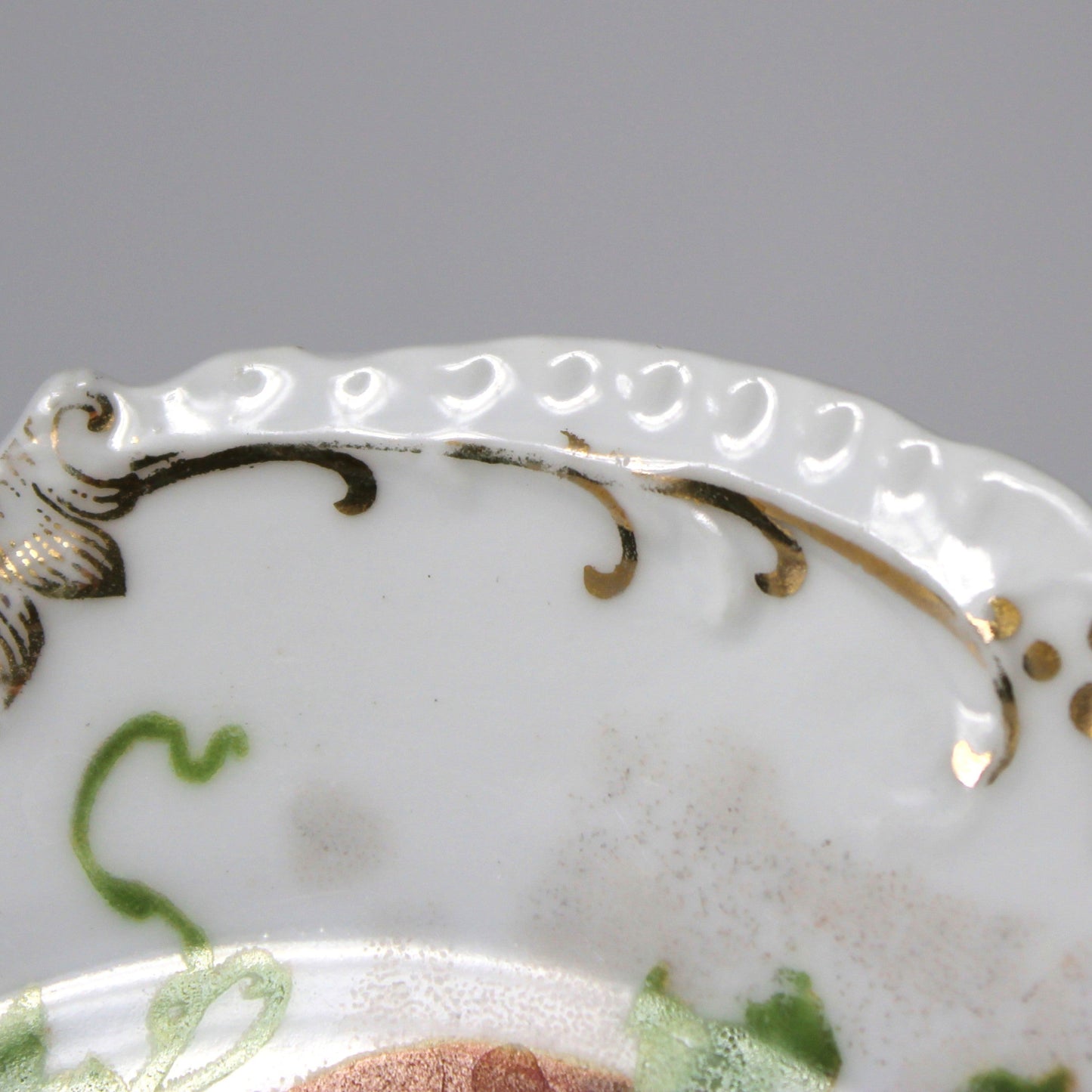 Decorative plate with intricate gold detailing on a white background