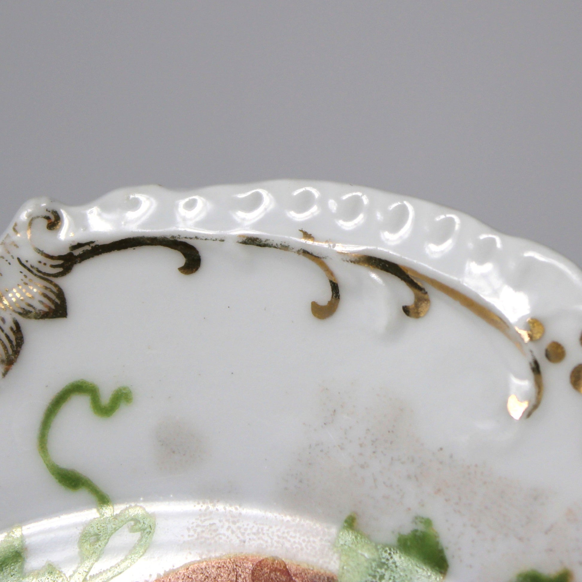 Decorative plate with intricate gold detailing on a white background