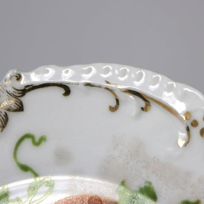 Decorative plate with intricate gold detailing on a white background