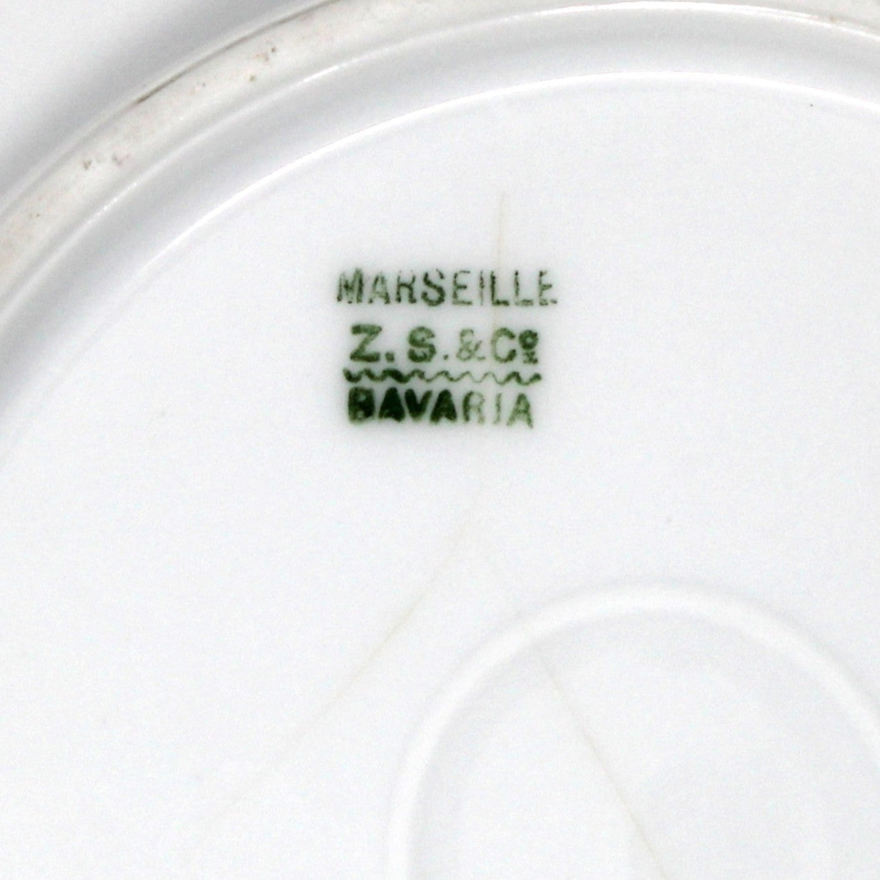Close-up of backstamp on porcelain plate with 'ZS&C' branding, Marseille pattern.