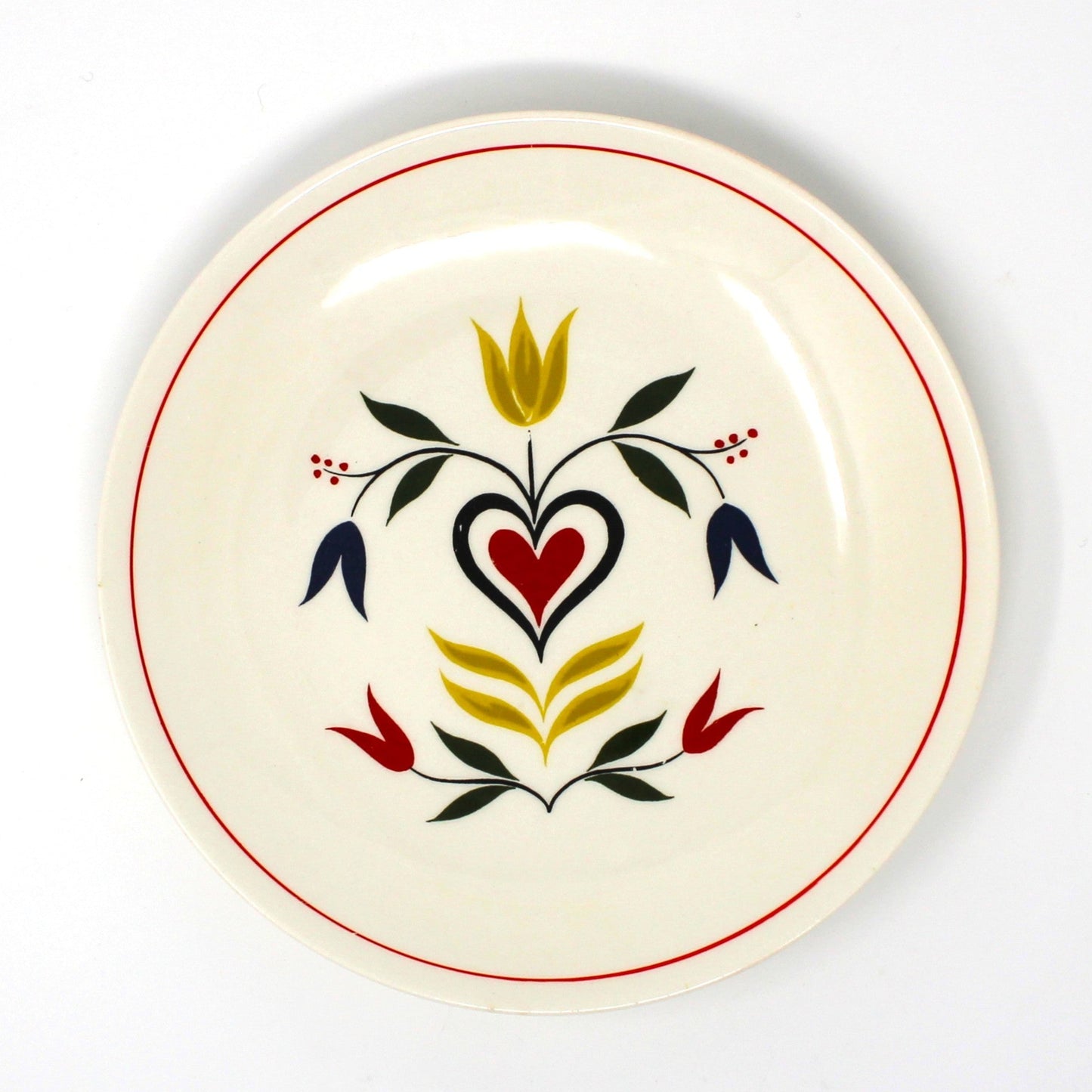 Decorative plate with a heart and floral design on a beige background