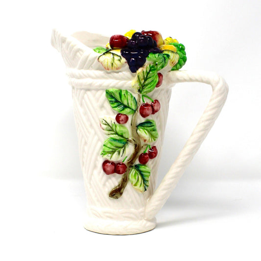 Lefton Tutti Frutti ceramic pitcher with fruit design on a basketweave ceramic background