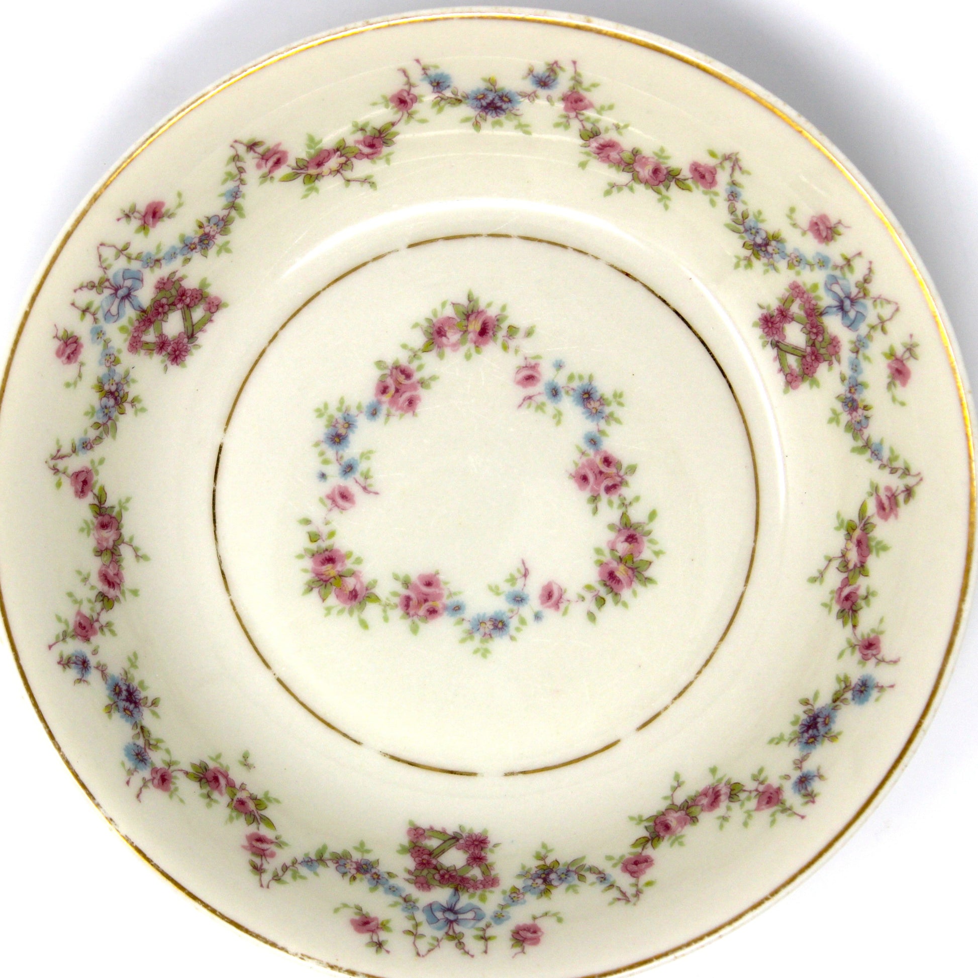 Decorative ceramic plate with floral pattern on a beige background