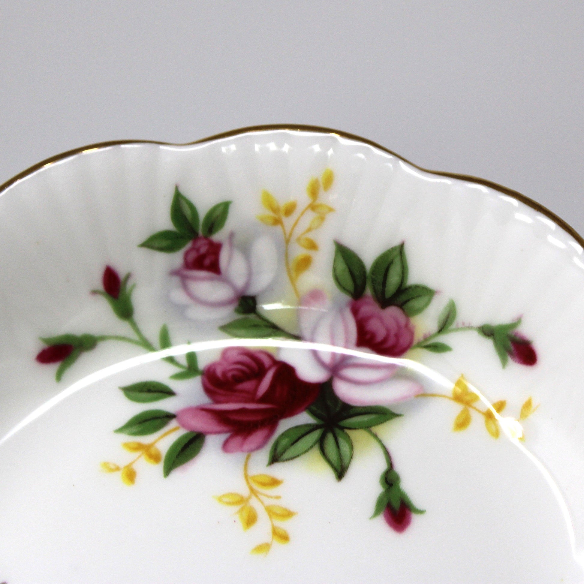 Decorative ceramic plate with floral design on a gray background