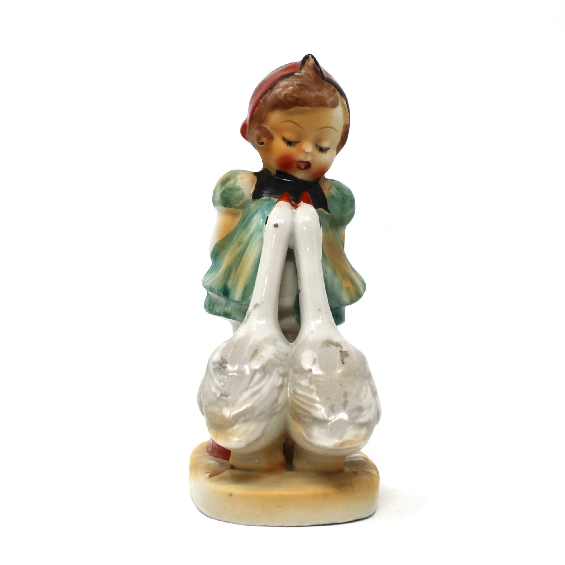 Small figurine of a girl with balloons on a white background