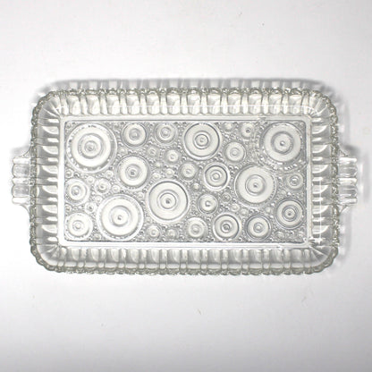 Clear glass snack tray from Anchor Hocking Serva Snack set.  Geometric circles pattern called Colonial Lady.