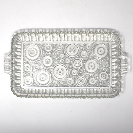 Clear glass snack tray from Anchor Hocking Serva Snack set.  Geometric circles pattern called Colonial Lady.