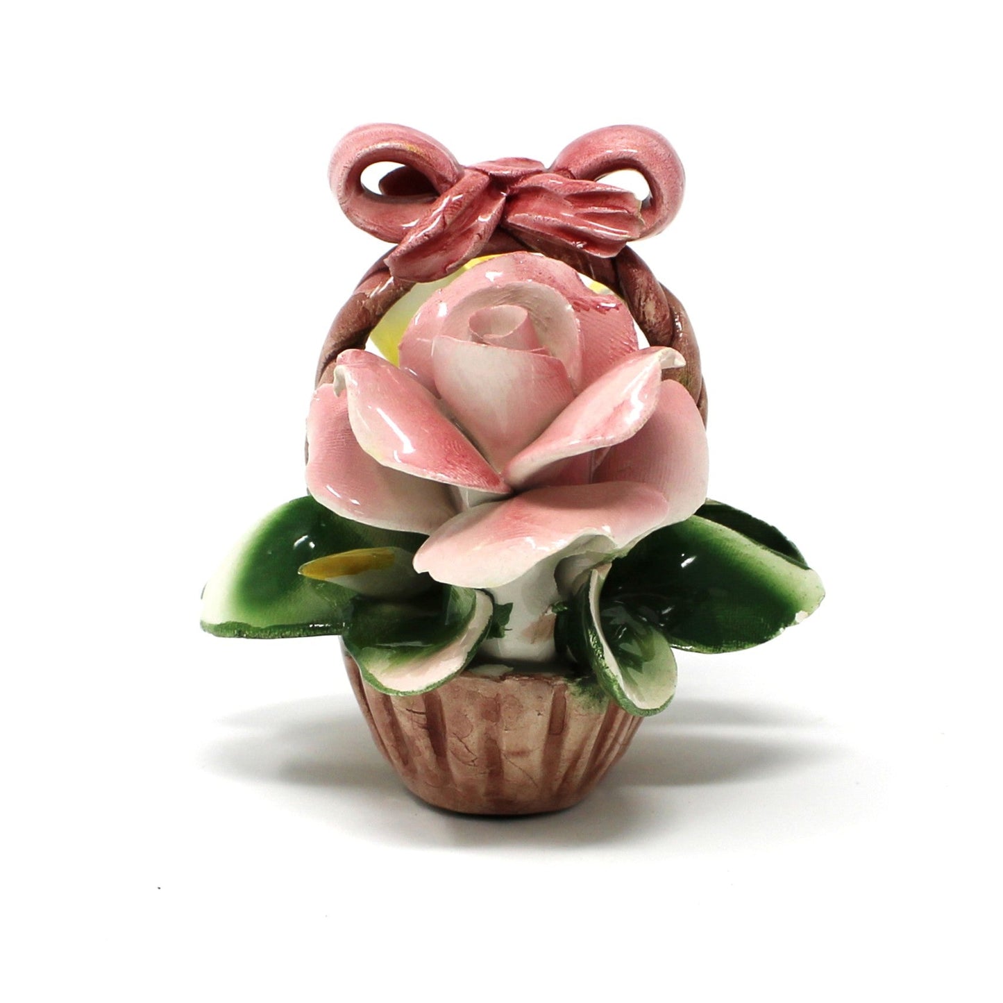 close up view of pink rose on Capodimonte floral basket.