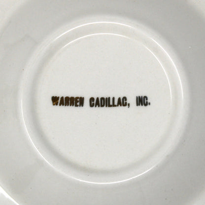 White ceramic plate with 'Warren Cadillac, Inc.' text on a white background