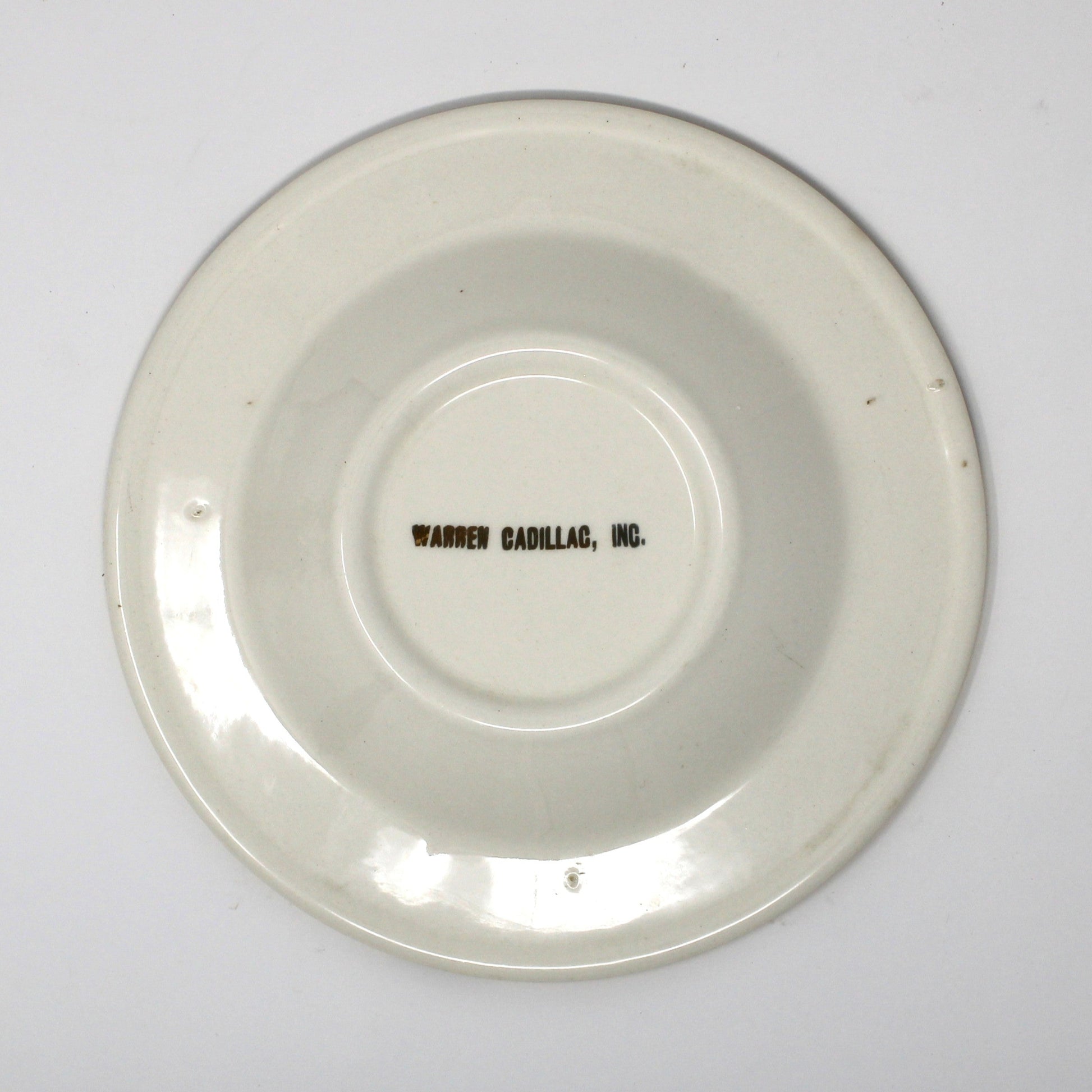 Back view of vintage advertising ashtray for Warren Cadillac Inc.