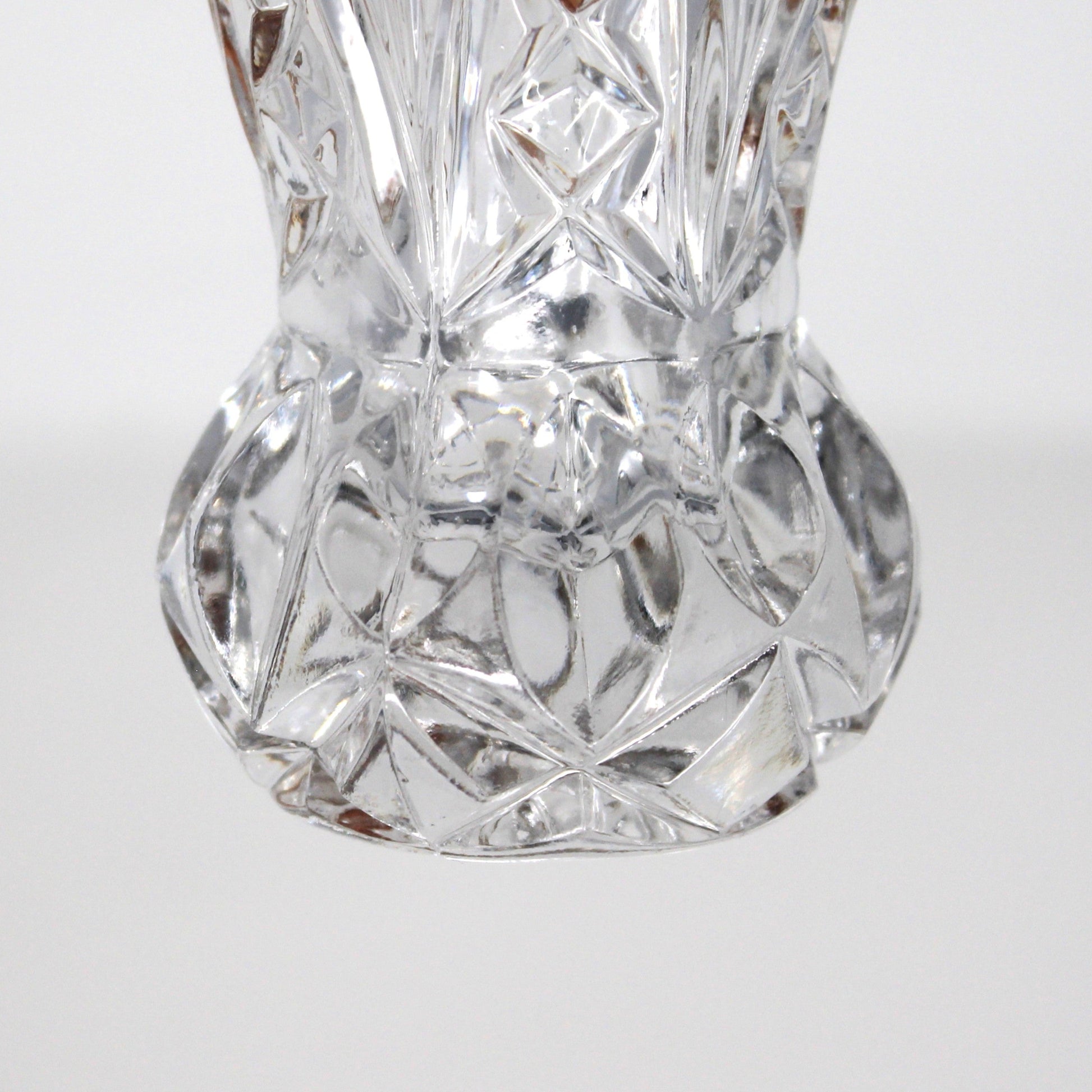 Close up view of bulbous base on vintage, intricately cut crystal, toothpick holder.  