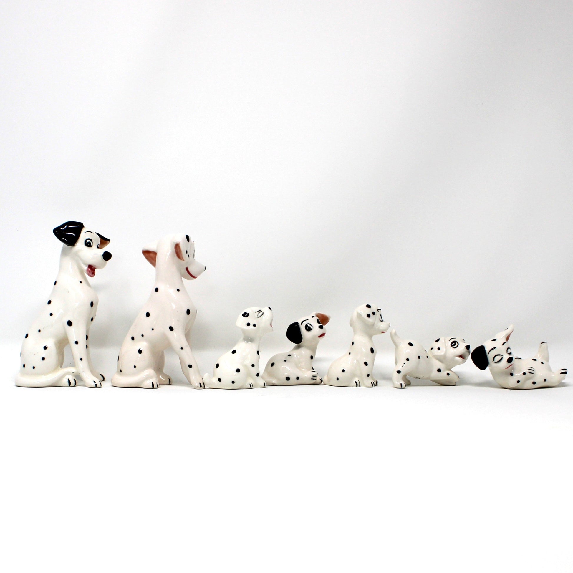 Set of Dalmatian figurines on a white background
