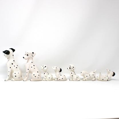 Row of Dalmatian dog figurines on a white background