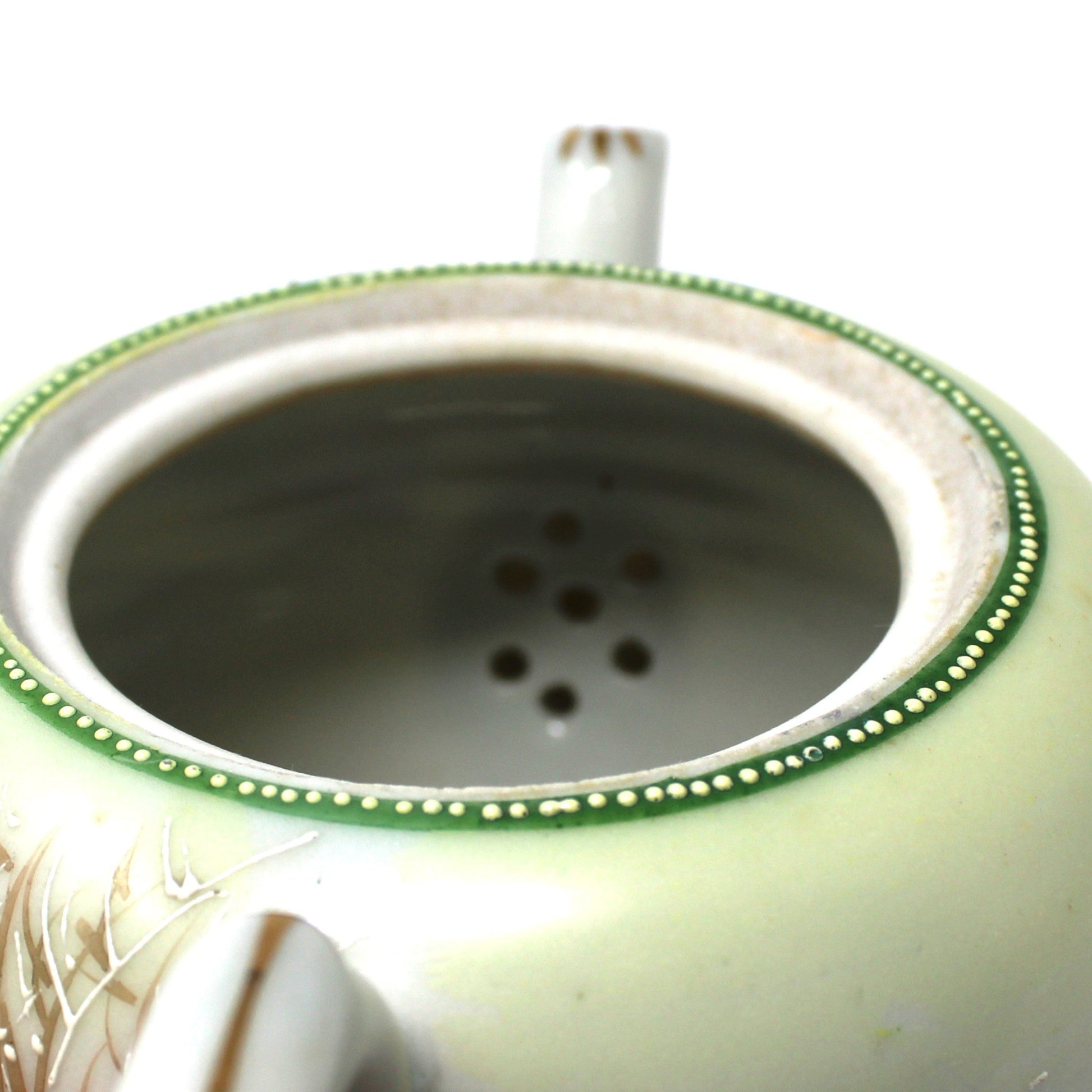 close up view of internal strainer on teapot.