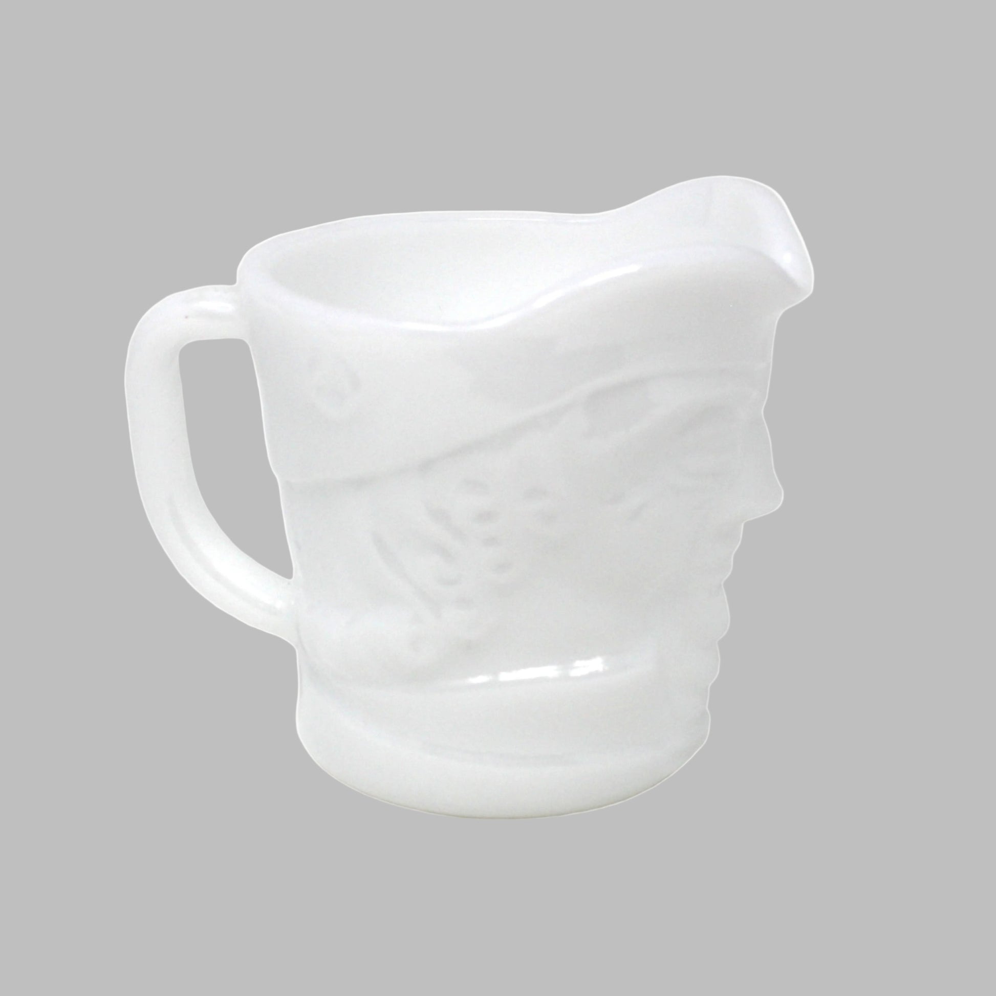 White ceramic pitcher on a white background