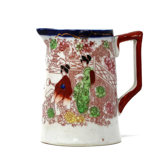 Geisha Girl creamer. Hand painted Oriental women in Pagoda garden. Cobalt blue rim.
