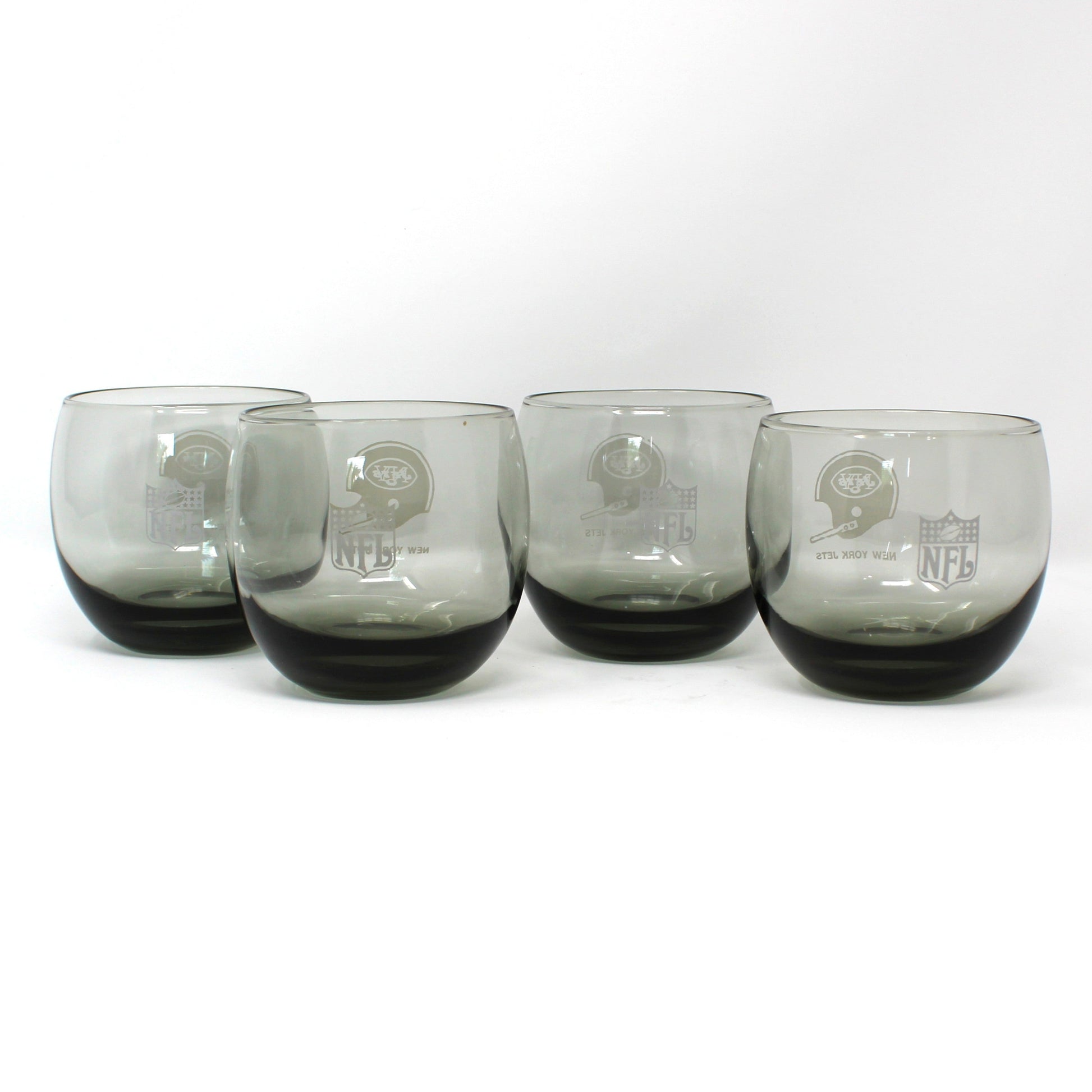 Vintage NFL Football glasses.  New York Jets smoked glass roly-poly collectible barware.