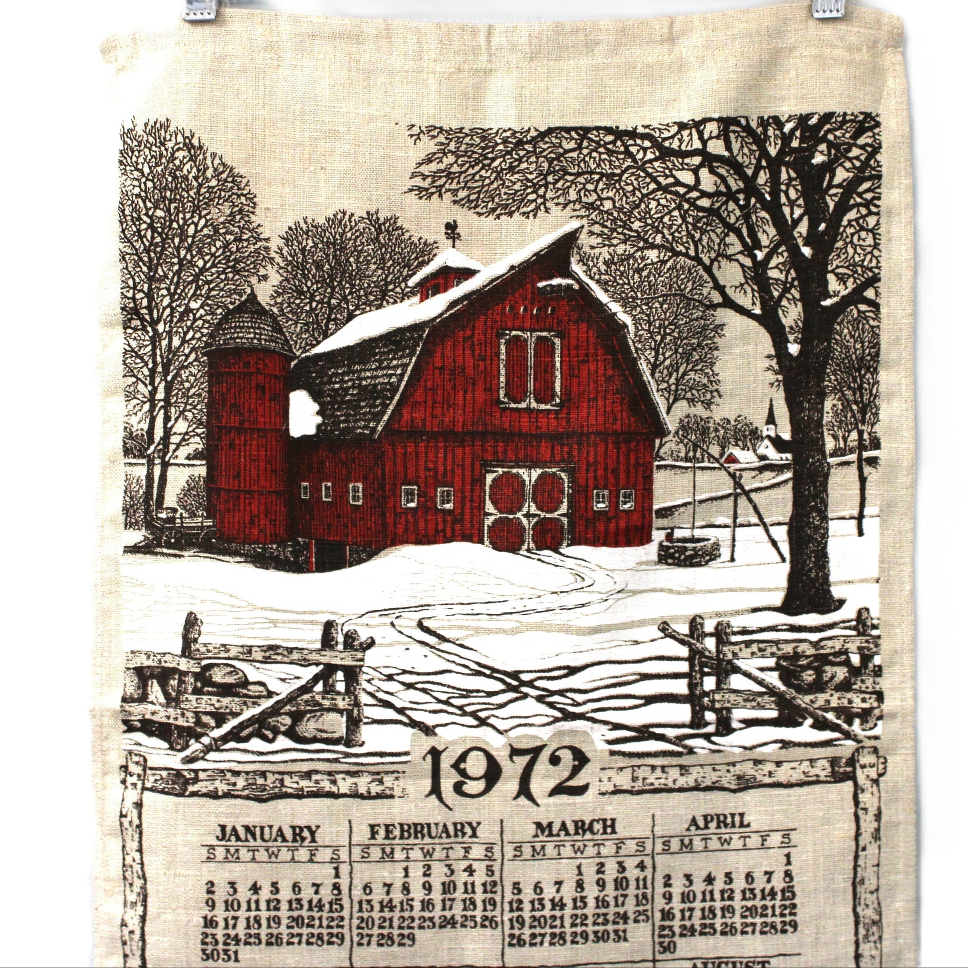 Fabric calendar with a red barn design and year 1972 on a white background