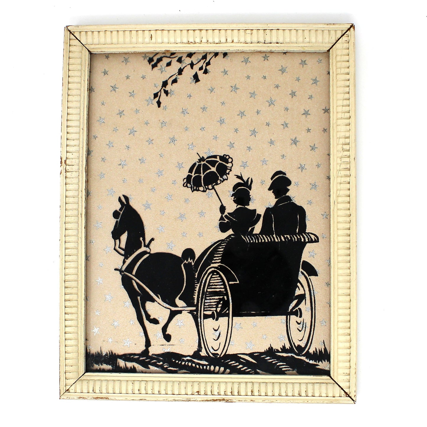 Framed silhouette artwork of a horse-drawn carriage with two figures on a white background with silver foil stars.