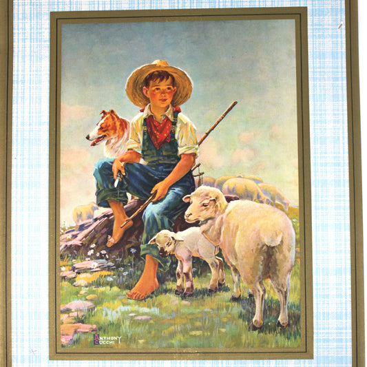 Framed artwork of a boy with sheep and a dog on a grassy hill.